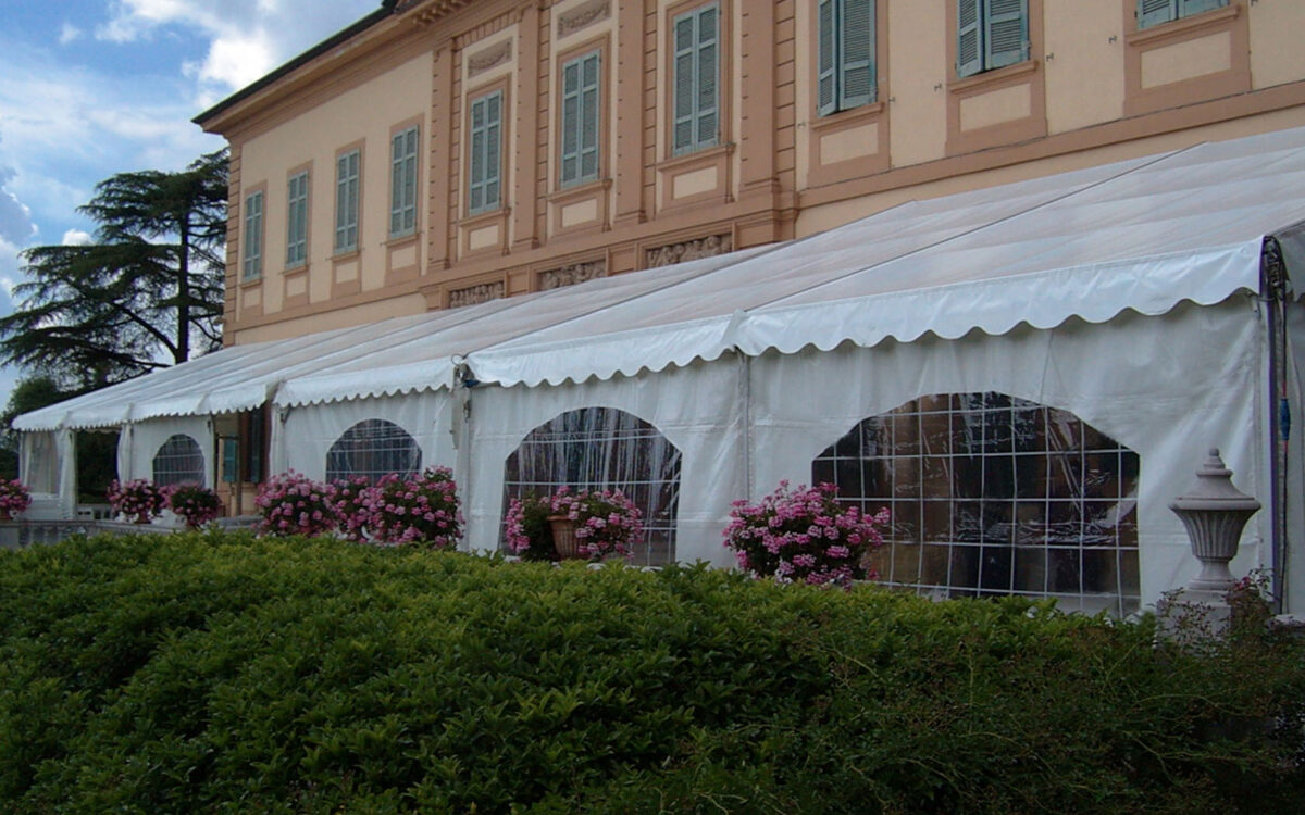 Tendostruttura monofalda con tamponamenti finestrati in pvc bianco allestita per cerimonia presso villa privata